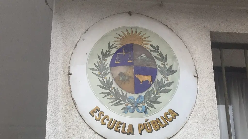 Escudo con la leyenda Escuela Pública en la fachada de un centro educativo de Montevideo. Foto: Fadesga / Wikimedia Commons (CC BY-SA 4.0) (archivo)