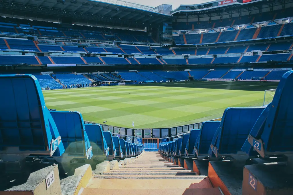 Cancha de fútbol iluminada de noche. Foto: Unsplash